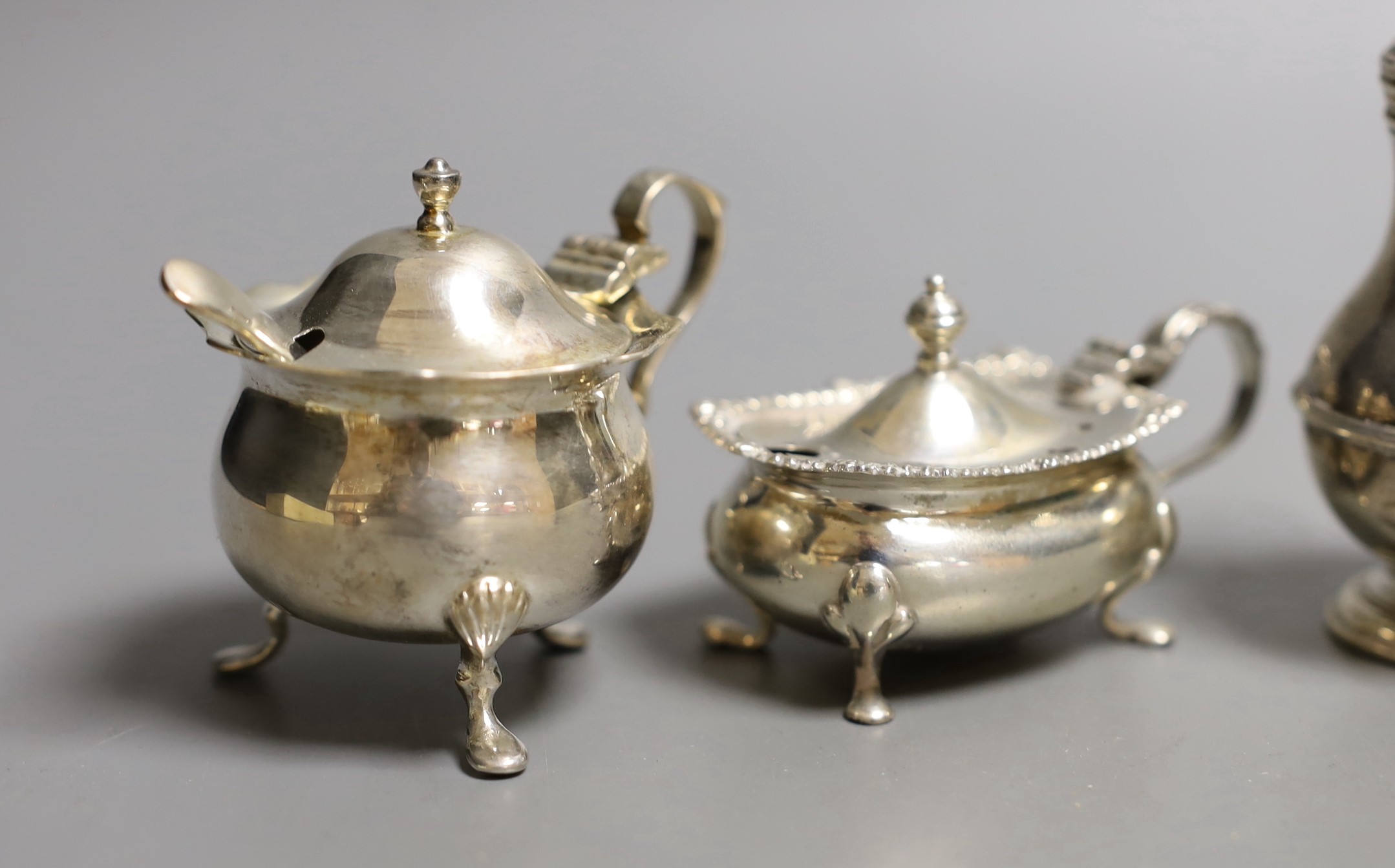 Seven assorted 20th century silver condiments including pepperettes and mustards.